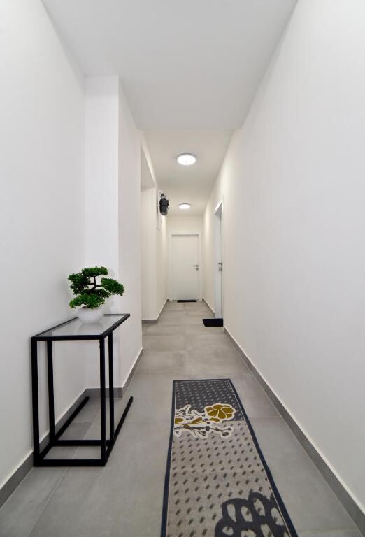 Corridor leading to the apartments at At queens